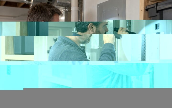 Homeowner safely checking the labels on a closed electrical panel